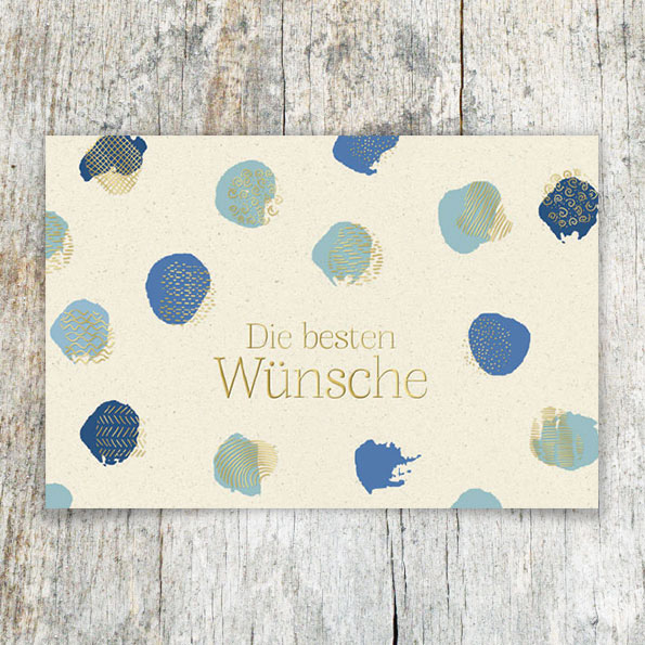 Vergrößerte Abbildung Grußkarten mit goldgeprägtem Schriftzug 'Die besten Wünsche' und blauen Farbklecksen auf strukturiertem Aquarellkarton